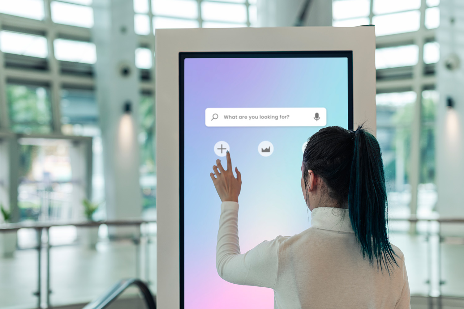 Woman interacting with large touchscreen