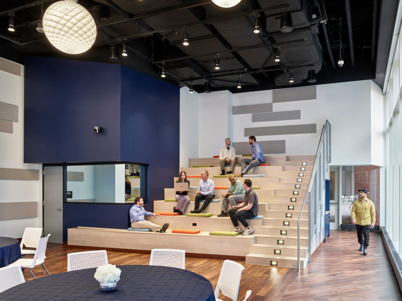 Bleachers in ChangeLab with several people sitting on them