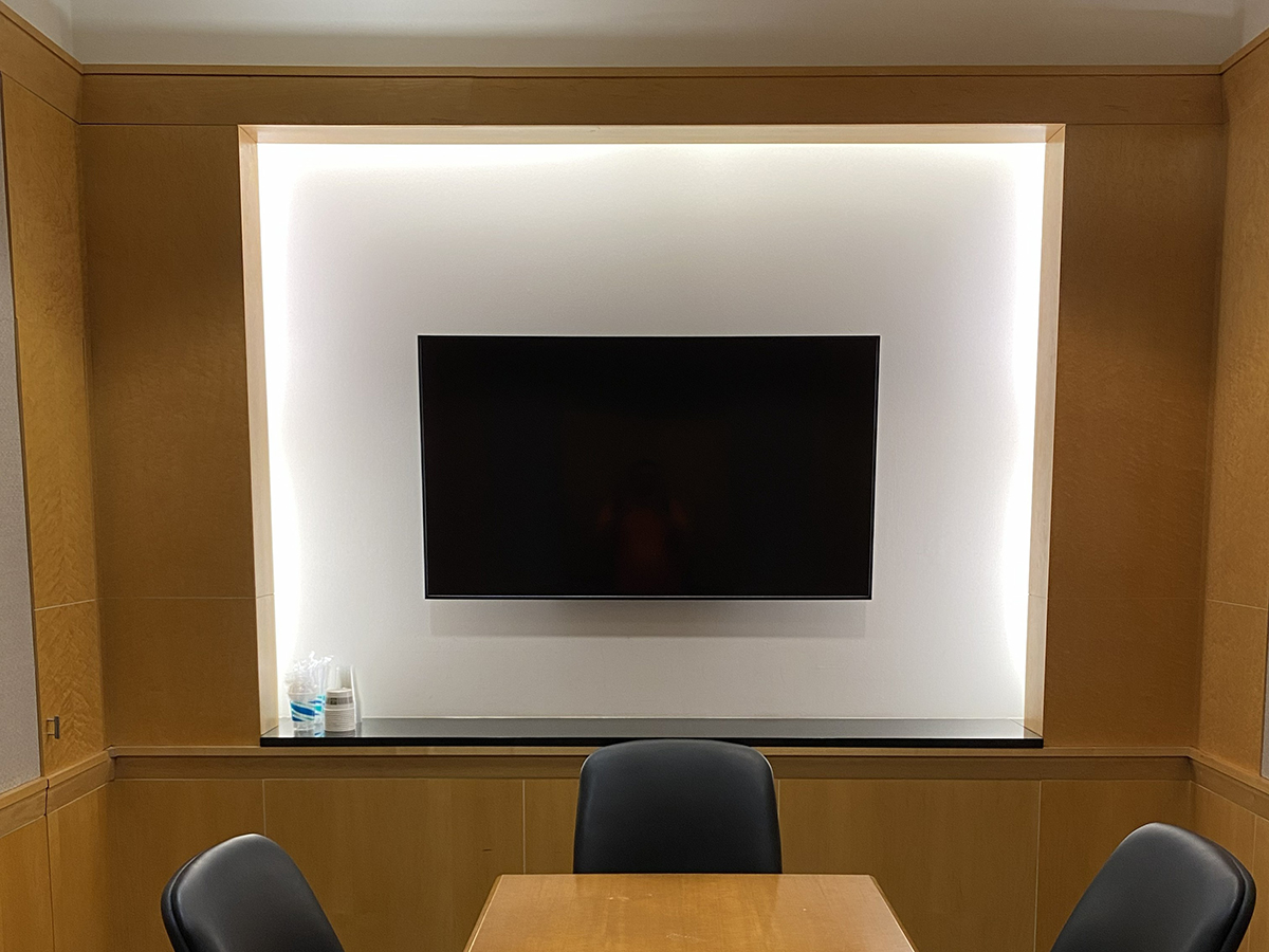Wall-mounted digital display in Merakey conference room