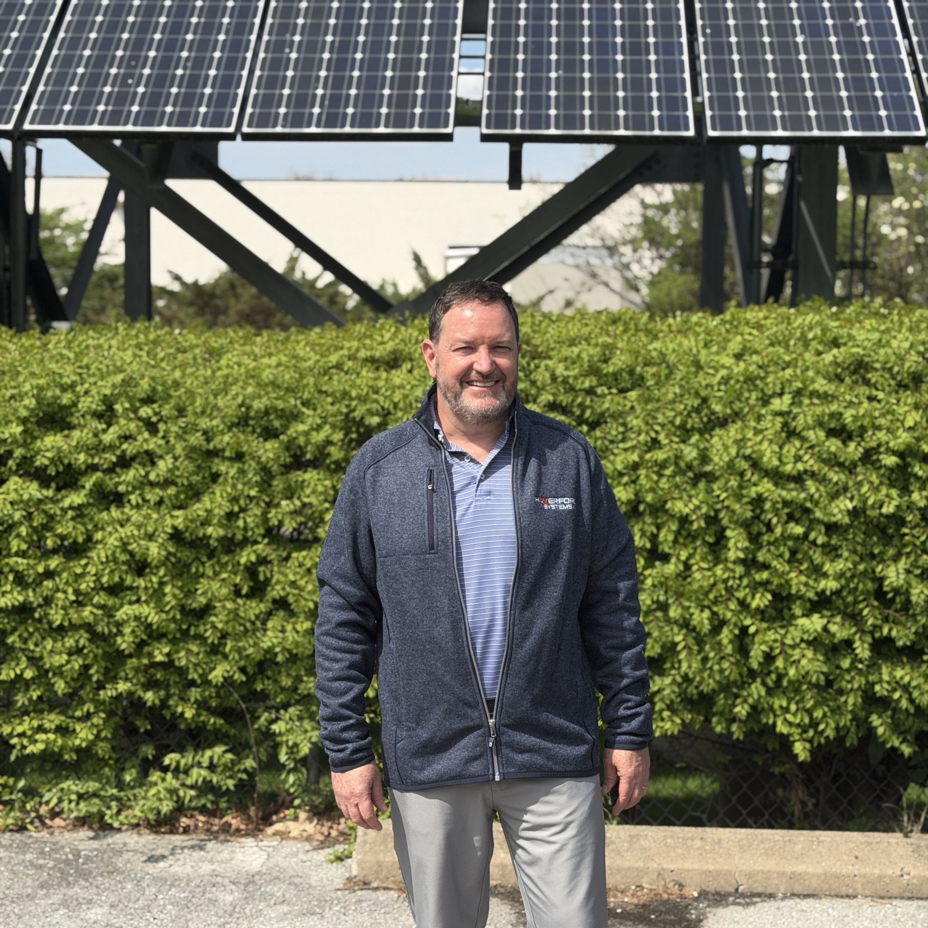 Jerry Donohue in front of solar panels